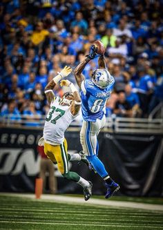 two football players jumping up in the air