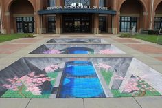 an artistic painting on the ground in front of a building