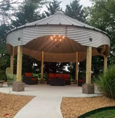 a gazebo with lights hanging from it's roof