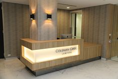 the front desk of a law office with lights on it's sides and an illuminated sign that reads colman cric