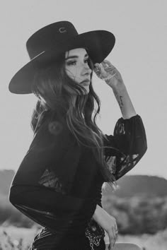 black and white photograph of a woman wearing a cowboy hat