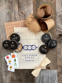 the garden seed kit is laid out on top of a wooden table with other items