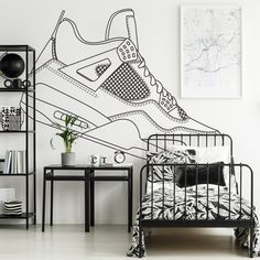 a black and white bedroom with a wall mural depicting a sneaker shoe on the bed