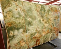 a large green marble slab in a warehouse