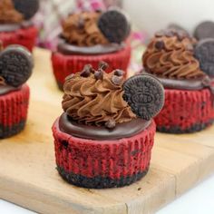 several red velvet cupcakes with chocolate frosting and oreo cookies on top