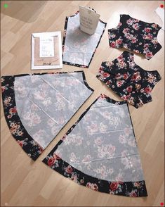 sewing supplies laid out on the floor to make a flowered dress with an apron