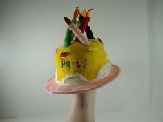 This colorful, unisex hat is the perfect accessory for that special someones birthday! Full of primary colors and and candles extending off the top and embroidered "Party", it is a wonderful way to celebrate that special person! Hat comes in several color options One Size Fits Most 6" Wide Available individually, 3-Pack, 6-Pack, & 12-Pack pricing Fun Costume Hats For Birthday, Fun Party Mini Hat With Curved Brim, Fun Costume Hats And Headpieces For Birthday Carnival, Fun Mini Cap Hats For Party, Novelty Curved Brim Hat For Birthday, Fun Curved Brim Hat For Birthday, Multicolor Cap For Birthday, Fun Curved Brim Hat For Birthdays, Fun Mini Hats For Birthday Carnival