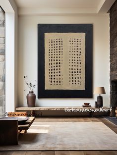 a living room with stone fireplace and art on the wall