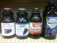 several bottles of blueberry juice on a shelf