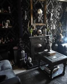 a living room filled with furniture and a fire place in front of a wallpapered wall