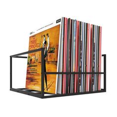 a stack of dvd's sitting on top of a metal rack in front of a white background