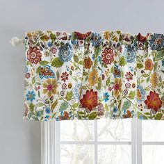 a window with a flowered valance hanging from it's side