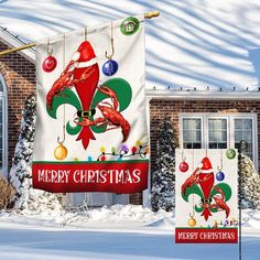 two christmas banners hanging from the side of a house