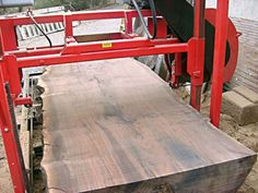 a large piece of wood sitting on top of a red cart