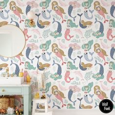 a bathroom with mermaid wallpaper and a mirror