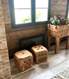 two wooden dice stools sitting in front of a fireplace