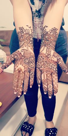 a woman with henna on her hands