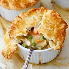 a close up of a pie in a dish with a spoon on the table next to it