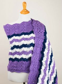 a purple and white crocheted sweater on a mannequin