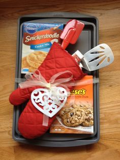 a tray with cookies, crackers and an oven mitt