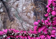 pink ruffles are on the edge of a camo background