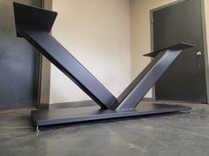 a metal sculpture sitting on top of a table in front of a wall and door