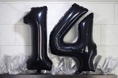 two black balloons that are shaped like the number forty