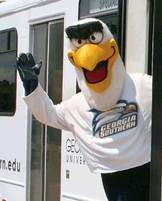 an eagle mascot waving out the window of a bus