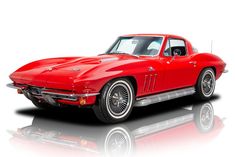 a red classic car is shown on a white background with reflection in the floor and it's hood up