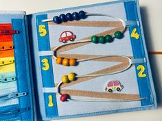 an open book with wooden beads and cars on it