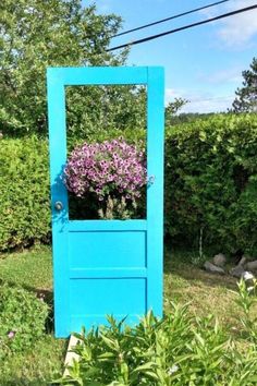 a blue door with purple flowers in it