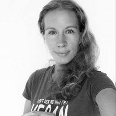 a black and white photo of a woman holding an apple