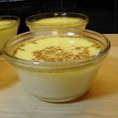 three bowls filled with food sitting on top of a wooden table