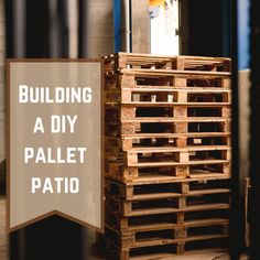 a pallet sitting next to a sign that says building a diy pallet patio