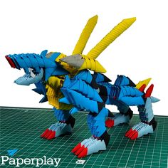 a paper model of a blue and yellow dragon