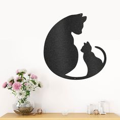 a cat and dog silhouette on a wall