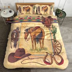 a bed with a cowboy themed comforter and pillow cases on top of the bed