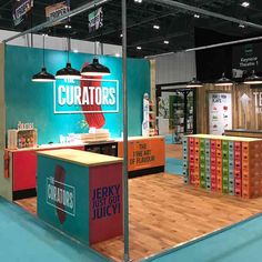 an exhibit stand with several different colored boxes on the floor and two lights hanging from the ceiling