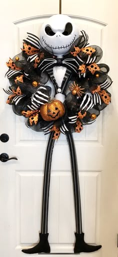 a halloween wreath is hanging on the front door