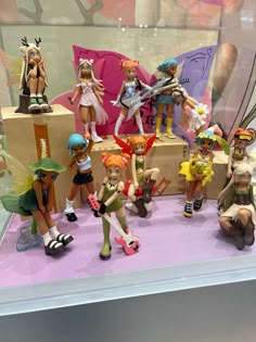 a display case filled with lots of toy figurines on top of a table