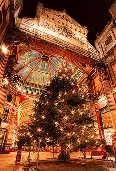 a christmas tree in the middle of a building with lights on it's branches