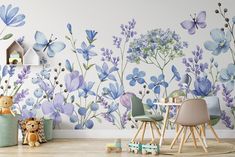 a child's room with blue flowers on the wall and toys in the foreground