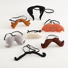 six different types of hair clips in various shapes and sizes, all with mustaches on them