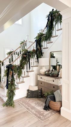 a staircase decorated with garland and pine cones