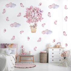 a bedroom with pink flowers and butterflies on the wall