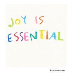 the word joy is essential written in colored crayons on a white paper background