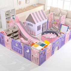 a pink and purple play set with a slide, ball pit, and toy house