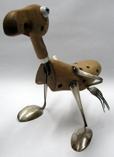 a metal object that looks like a dog with its legs spread out and eyes closed