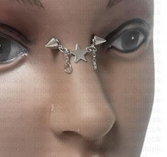 a close up of a mannequin's face with piercings on it