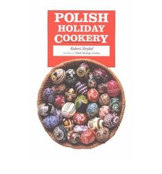 the polish holiday cooker book is open to show it's colorful eggs in a basket